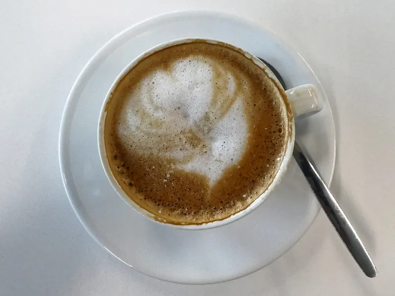 Flat white with latte art in a white cup